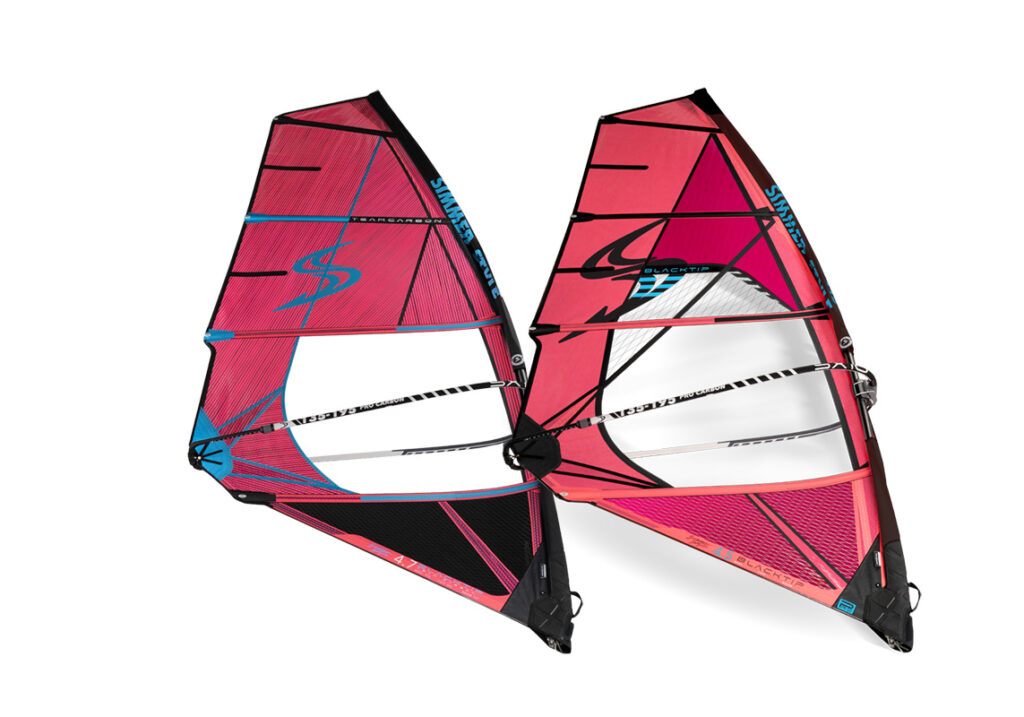 Pair of pink windsurfing sails with blue accents, shown side by side against a white background.